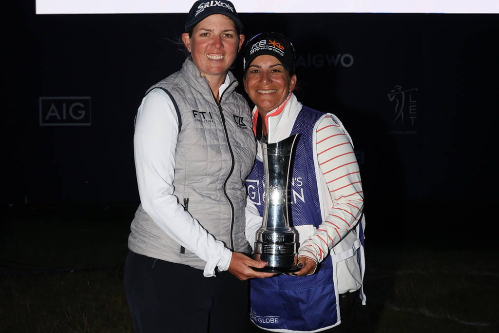 Ashleigh Buhai (left) and her caddie Tanya Paterson pose with the trophy after winning the AIG Women's Open at Muirfield in 2022.